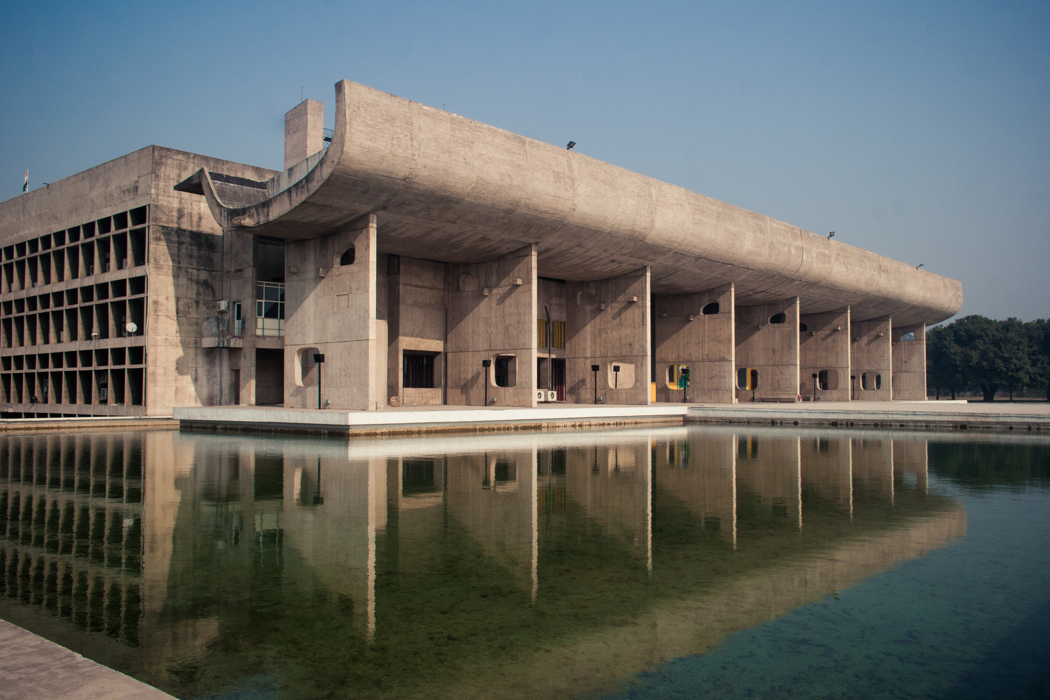 photograph showing the water feature, front facade and part of the left side of the Palace of Assembly in Chandrigarh